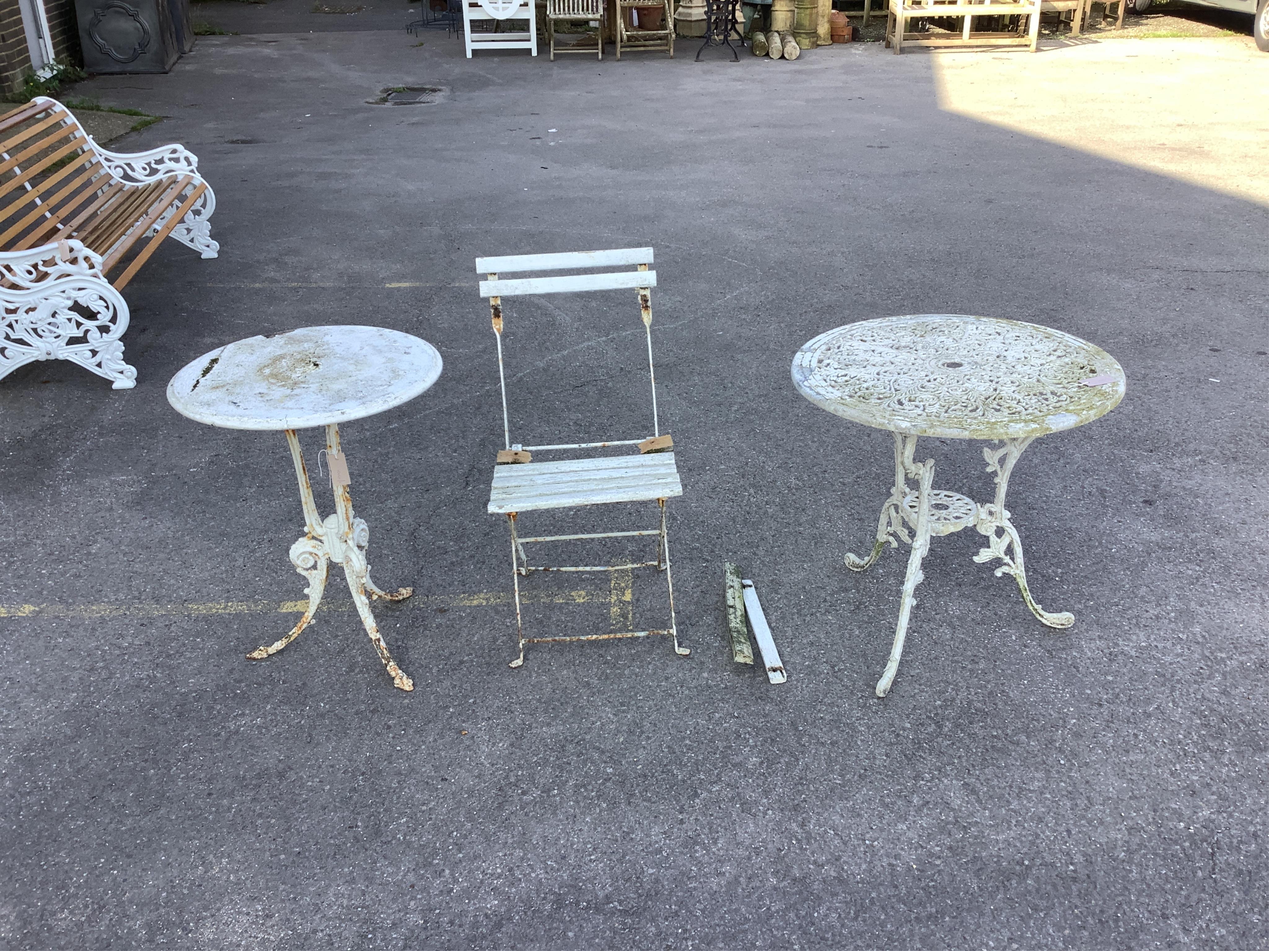 A Victorian cast iron circular garden table, a Victorian style circular aluminium garden table and chair, largest diameter 67cm, height 66cm. Condition - poor to fair